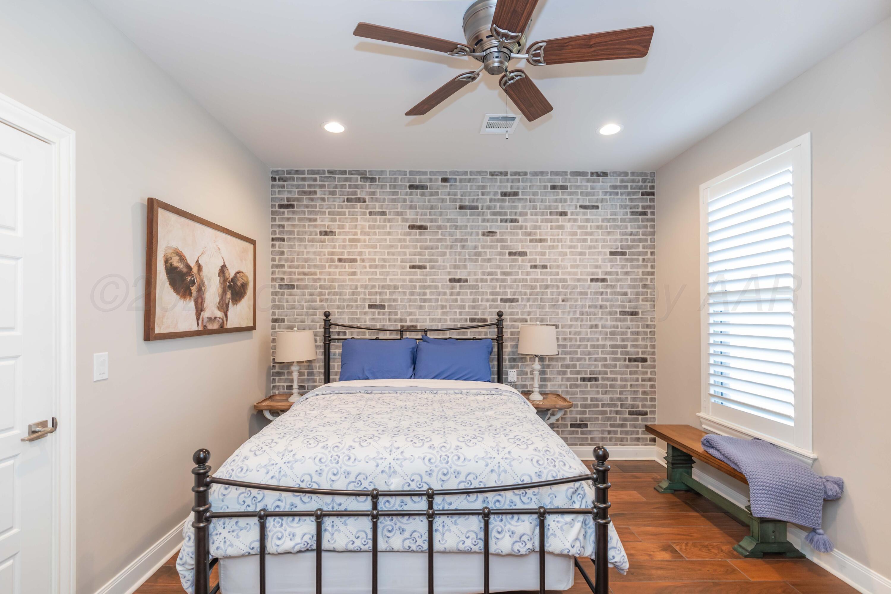 2809 Pensacola Avenue Amarillo, TX 79118 - Photo 25 of 36 a bedroom with a bed and a chandelier