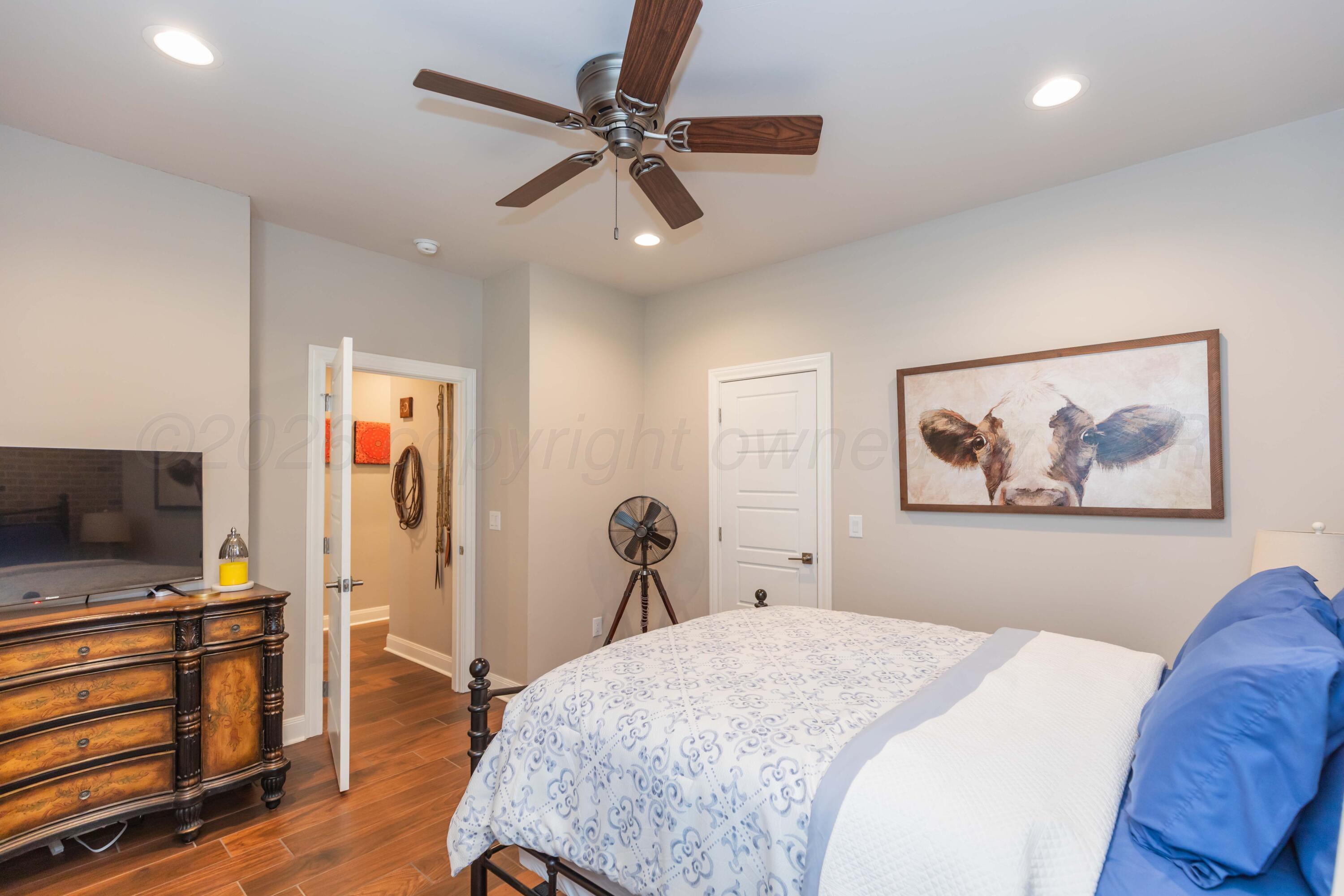 2809 Pensacola Avenue Amarillo, TX 79118 - Photo 27 of 36 a bedroom with a bed and a flat screen tv