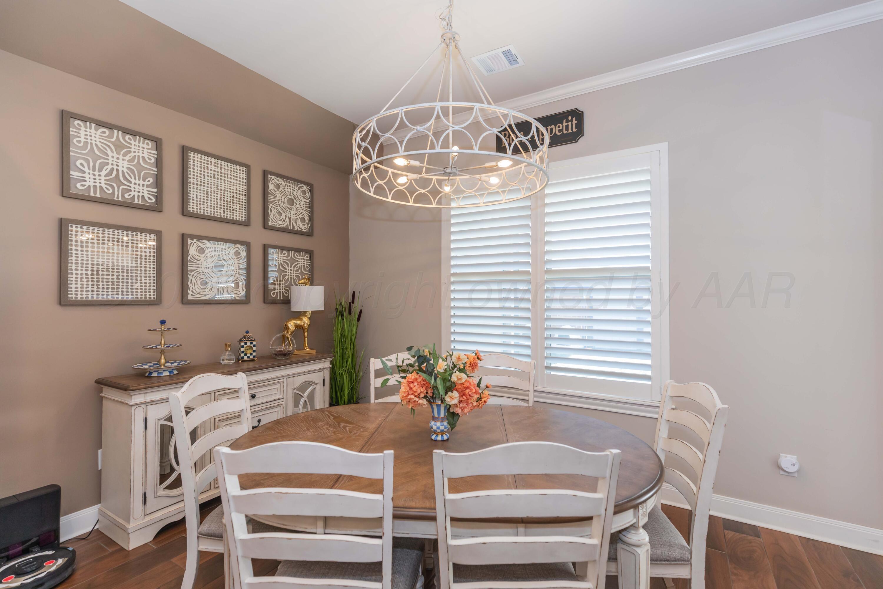2809 Pensacola Avenue Amarillo, TX 79118 - Photo 29 of 36 a view of a dining room with furniture a chandelier and wooden floor