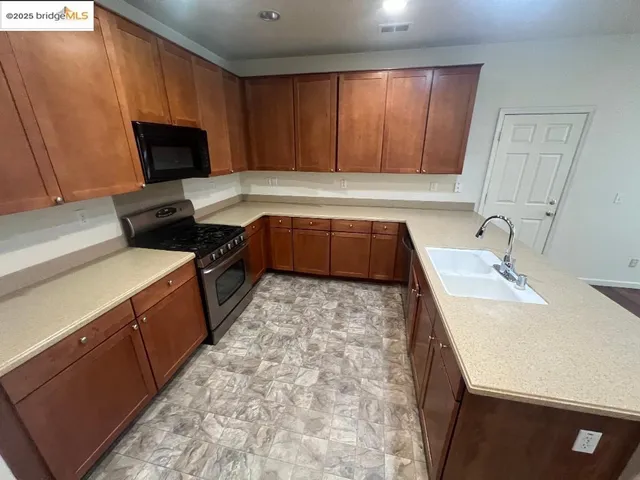 a kitchen with a stove a sink and a microwave