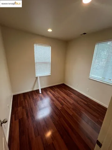 a view of an empty room and wooden floor