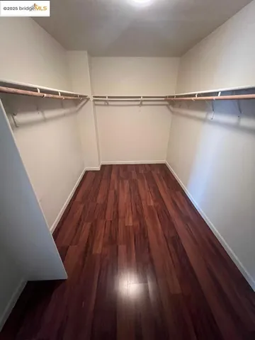 a view of a room with wooden floors