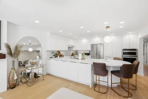 a kitchen with stainless steel appliances granite countertop a refrigerator and a sink
