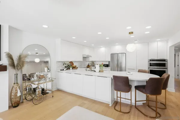 a kitchen with stainless steel appliances granite countertop a refrigerator and a sink