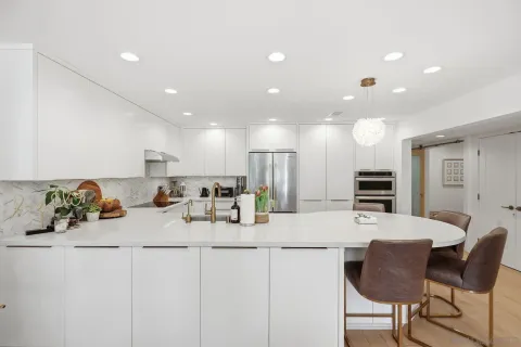 a table with chairs and a potted plant