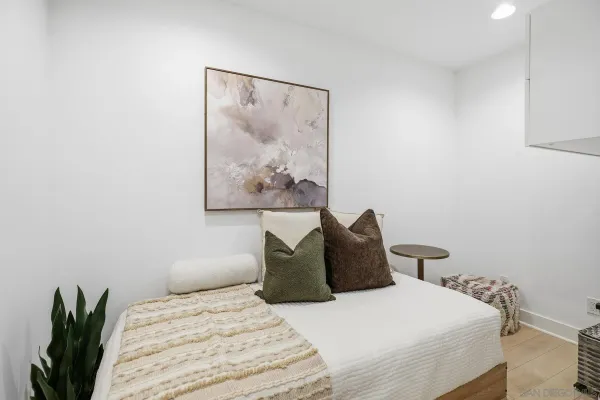 a bedroom with a bed and a flat screen tv