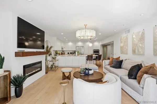 a living room with furniture and a chandelier