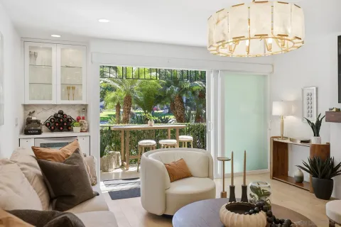 a view of a patio with a table and chairs under a large tree
