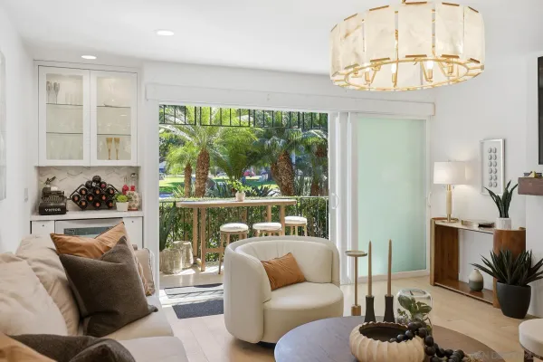 a view of a patio with a table and chairs under a large tree
