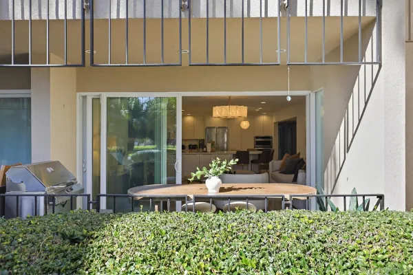 a kitchen with a sink and chairs