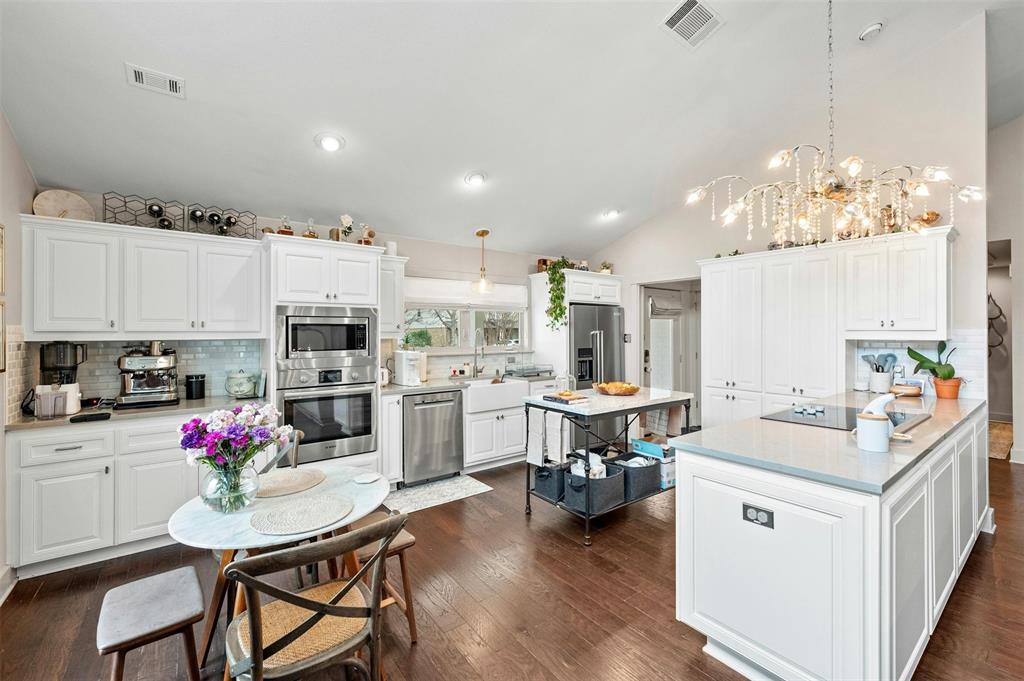 2802 Warren Street, Unit A Austin, TX 78703 - Photo 8 of 29 a kitchen that has a lot of cabinets in it and wooden floors