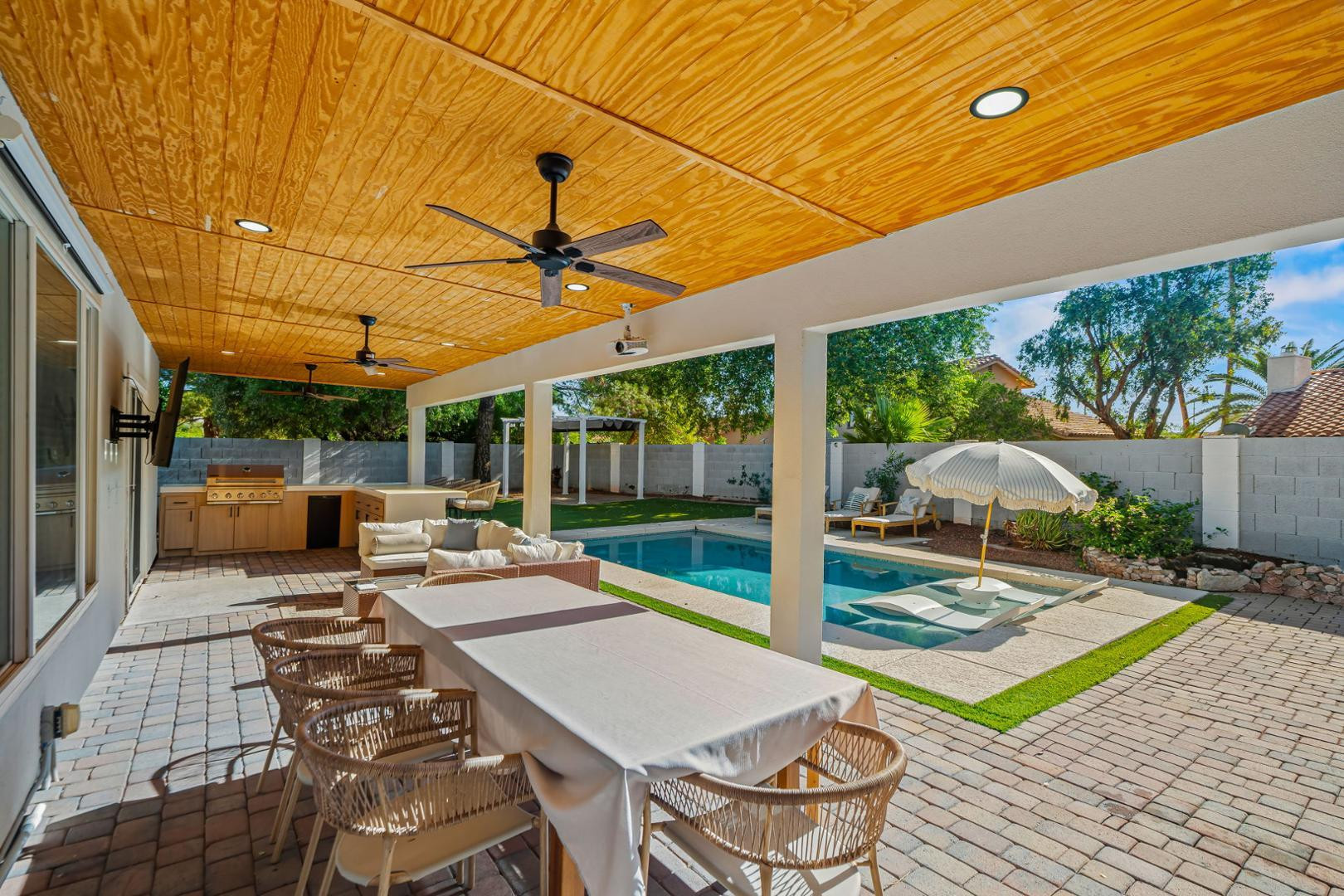 5449 East Phelps Road Scottsdale, AZ 85254 - Photo 24 of 28 a view of a patio with a dining table and chairs with wooden floor