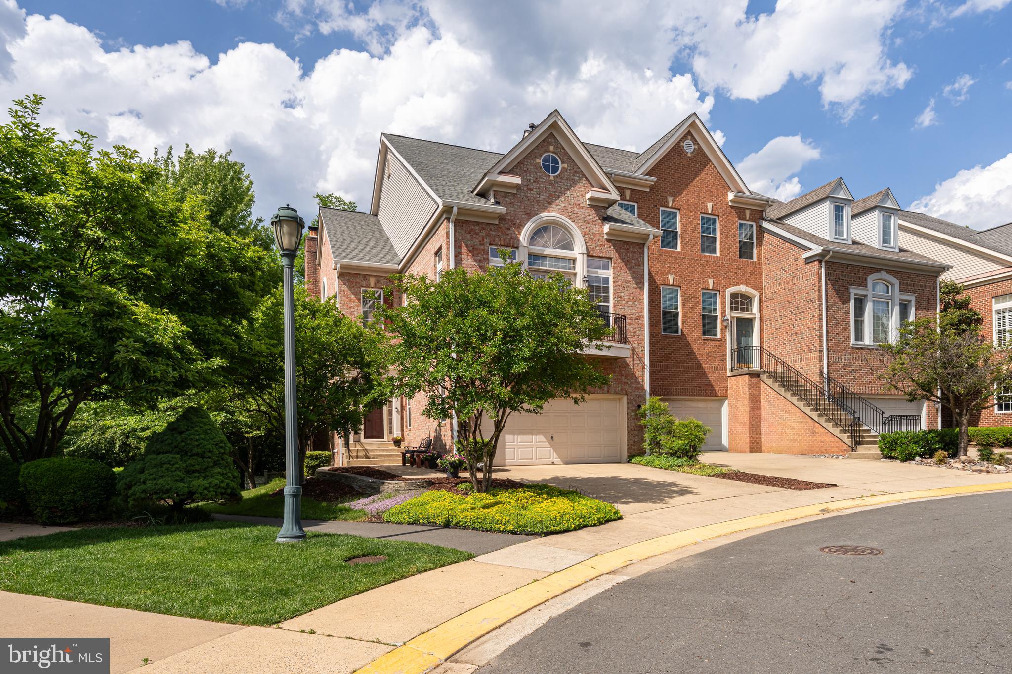 1925 Logan Manor Drive Reston, VA 20190 - Photo 2 of 61 a front view of a house with a yard