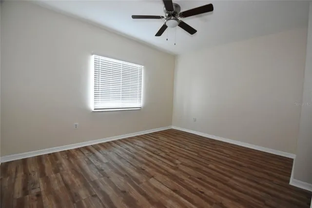 a view of a room with wooden floor and windows