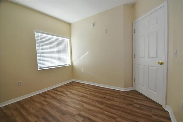 a view of a room with wooden floor and windows