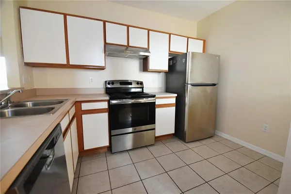 a kitchen with stainless steel appliances a refrigerator sink and stove