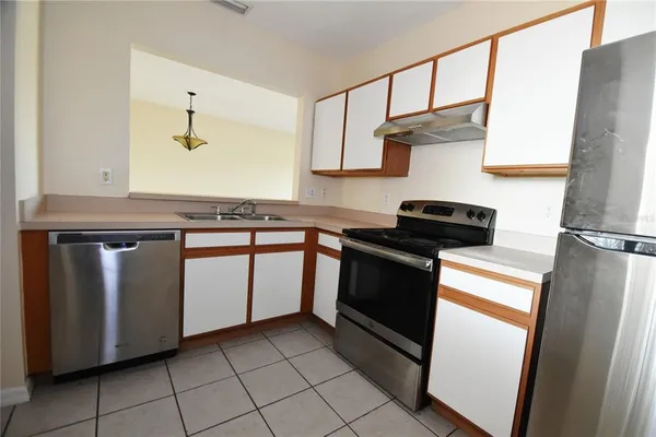 a kitchen with granite countertop white cabinets and white appliances