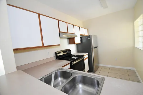 a kitchen with a refrigerator and a sink