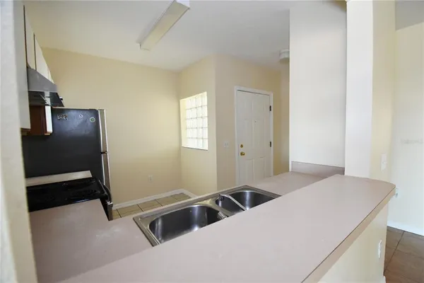 a kitchen with a refrigerator and a sink