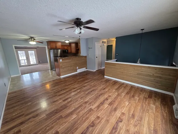 a view of livingroom with hardwood floor and a ceiling fan