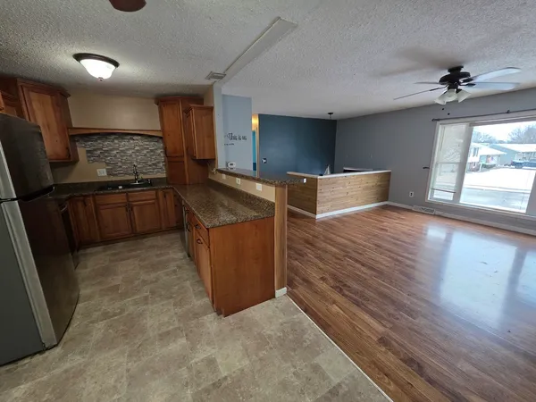a kitchen with stainless steel appliances granite countertop a refrigerator and a stove