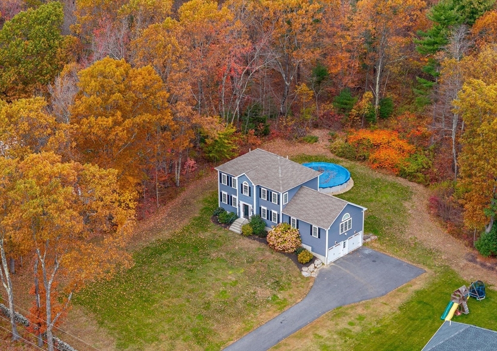 81 Central Tree Road Rutland, MA 01543 - Photo 1 of 31 an aerial view of a house with swimming pool and large trees