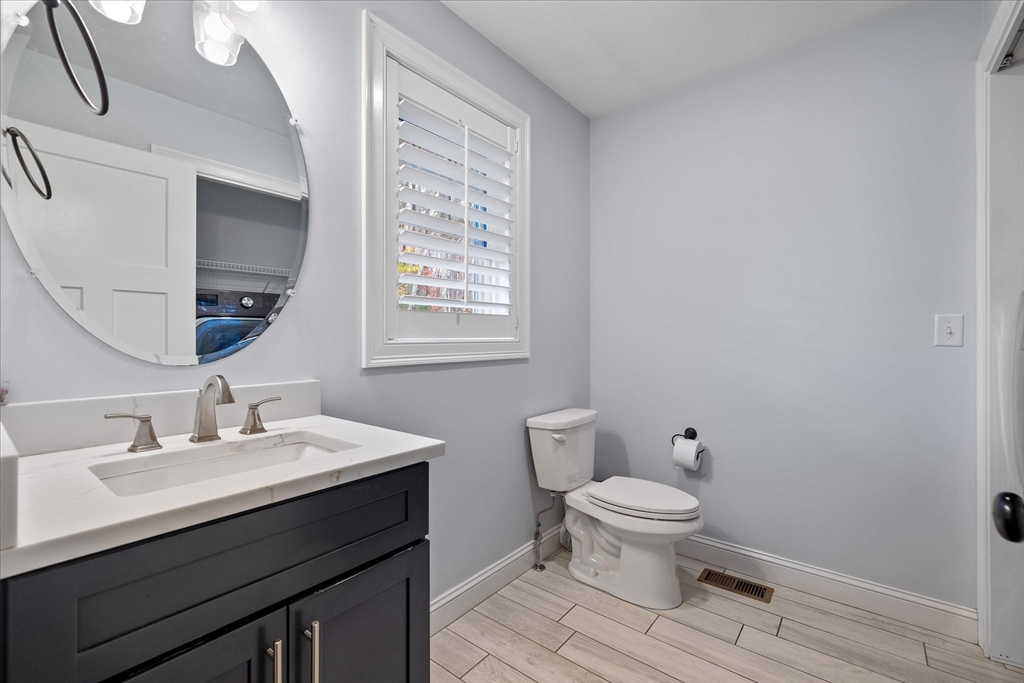 81 Central Tree Road Rutland, MA 01543 - Photo 15 of 31 a bathroom with a sink a toilet a mirror and a window