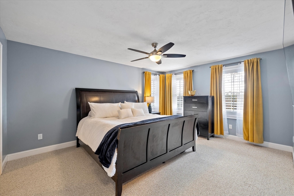 81 Central Tree Road Rutland, MA 01543 - Photo 16 of 31 a bed room with a bed and a ceiling fan