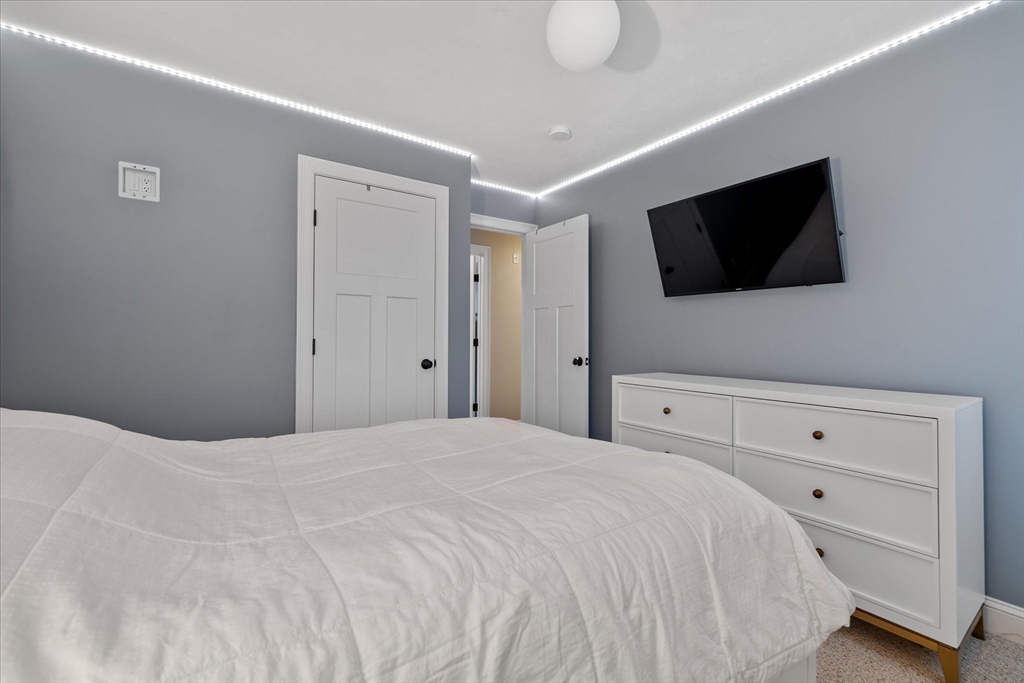 81 Central Tree Road Rutland, MA 01543 - Photo 20 of 31 a bedroom with a bed a flat screen tv and a lamp on the dresser