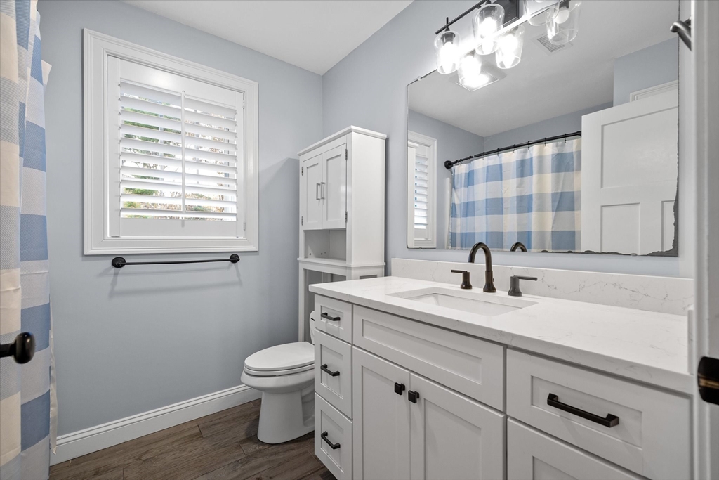 81 Central Tree Road Rutland, MA 01543 - Photo 22 of 31 a bathroom with a granite countertop sink a toilet and a mirror