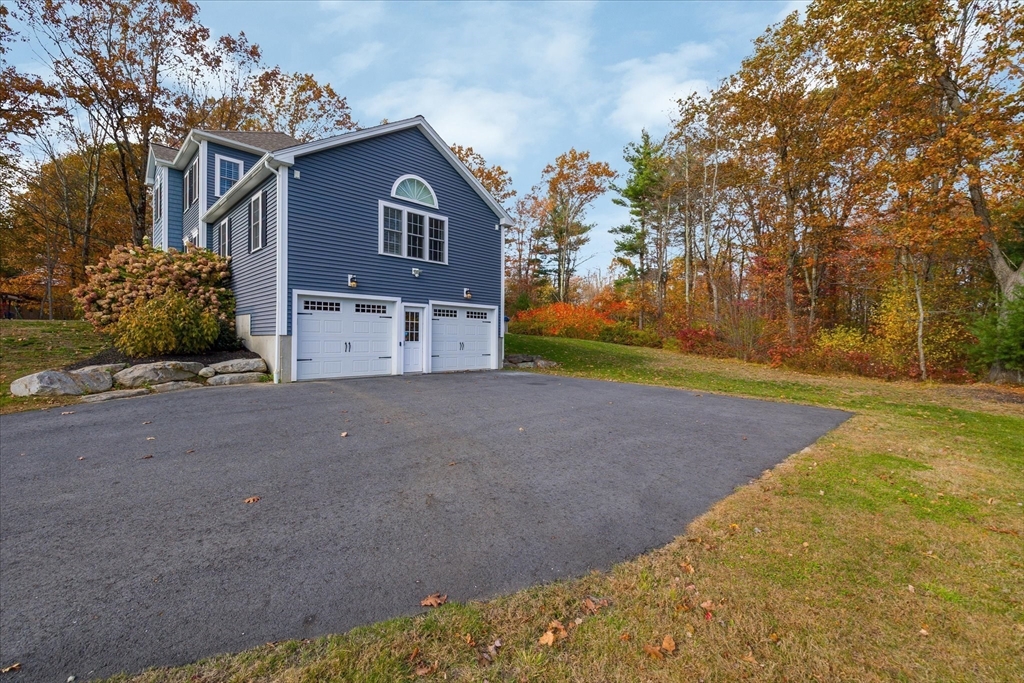 81 Central Tree Road Rutland, MA 01543 - Photo 25 of 31 a front view of a house with a yard and garage