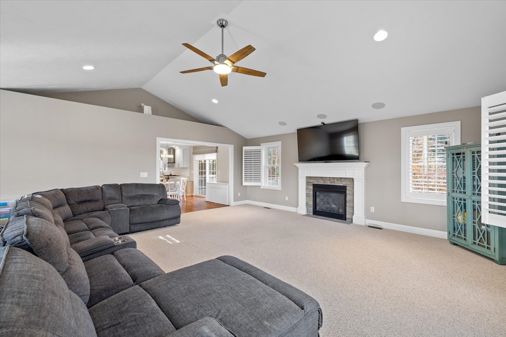 81 Central Tree Road Rutland, MA 01543 - Photo 9 of 31 a living room with furniture a fireplace and a flat screen tv