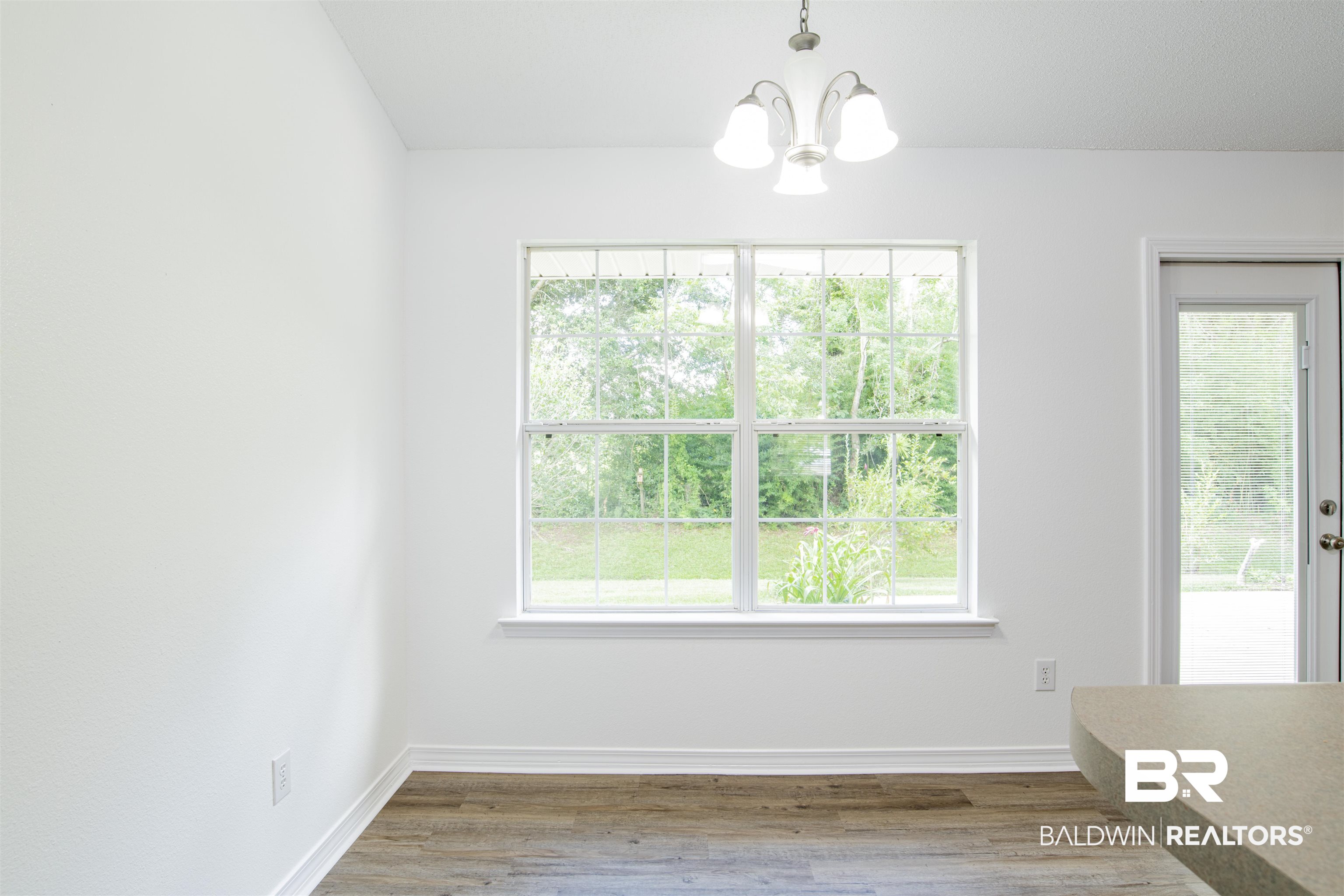 165 Pemberton Loop Fairhope, AL 36532 - Photo 12 of 25 Unfurnished dining area with baseboards, wood finished floors, and a chandelier
