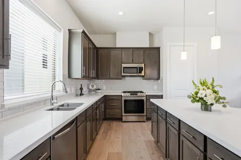 a kitchen with a sink stove and refrigerator
