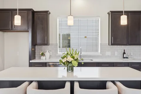 a kitchen with a table and chairs
