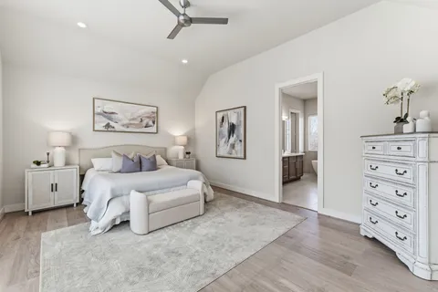 a spacious bedroom with a bed and a cabinets