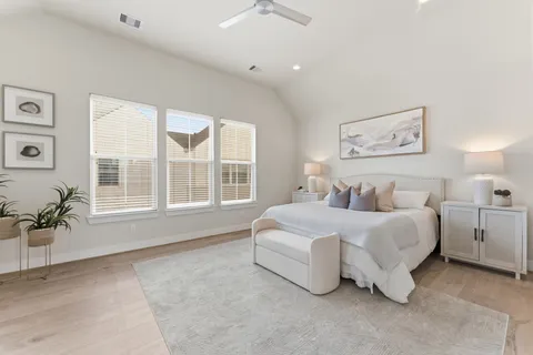 a spacious bedroom with a bed and a table