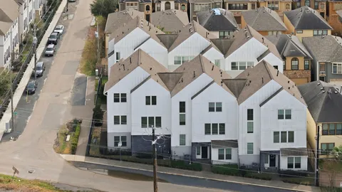 an aerial view of residential houses with street view