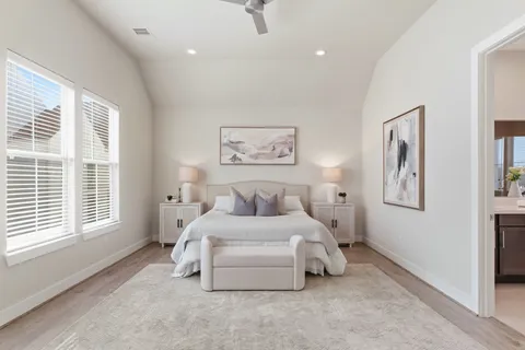 a bedroom with a bed and a large window