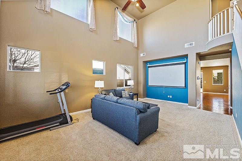 10460 Blockade Drive Reno, NV 89521 - Photo 4 of 25 a living room with furniture gym equipment and a granite counter tops