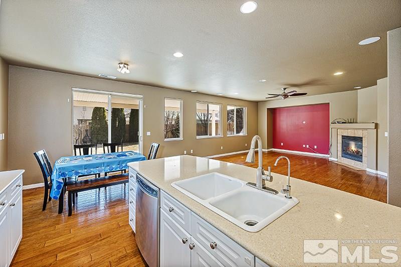 10460 Blockade Drive Reno, NV 89521 - Photo 7 of 25 a bathroom with a granite countertop sink and a large mirror