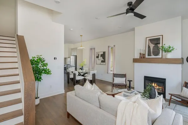 a living room with furniture fireplace and potted plant