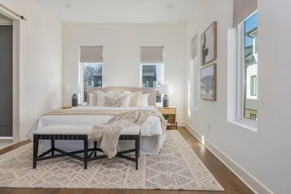 a bed sitting in a bedroom next to a window
