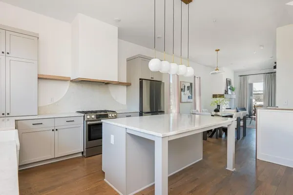 a kitchen with a stove a sink and a refrigerator