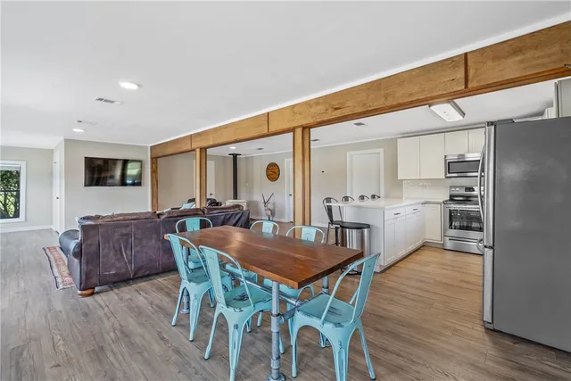 a view of a dining room with furniture and wooden floor