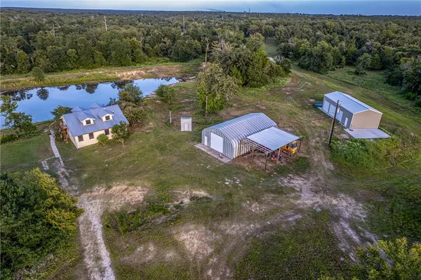 an aerial view of a house with a yard