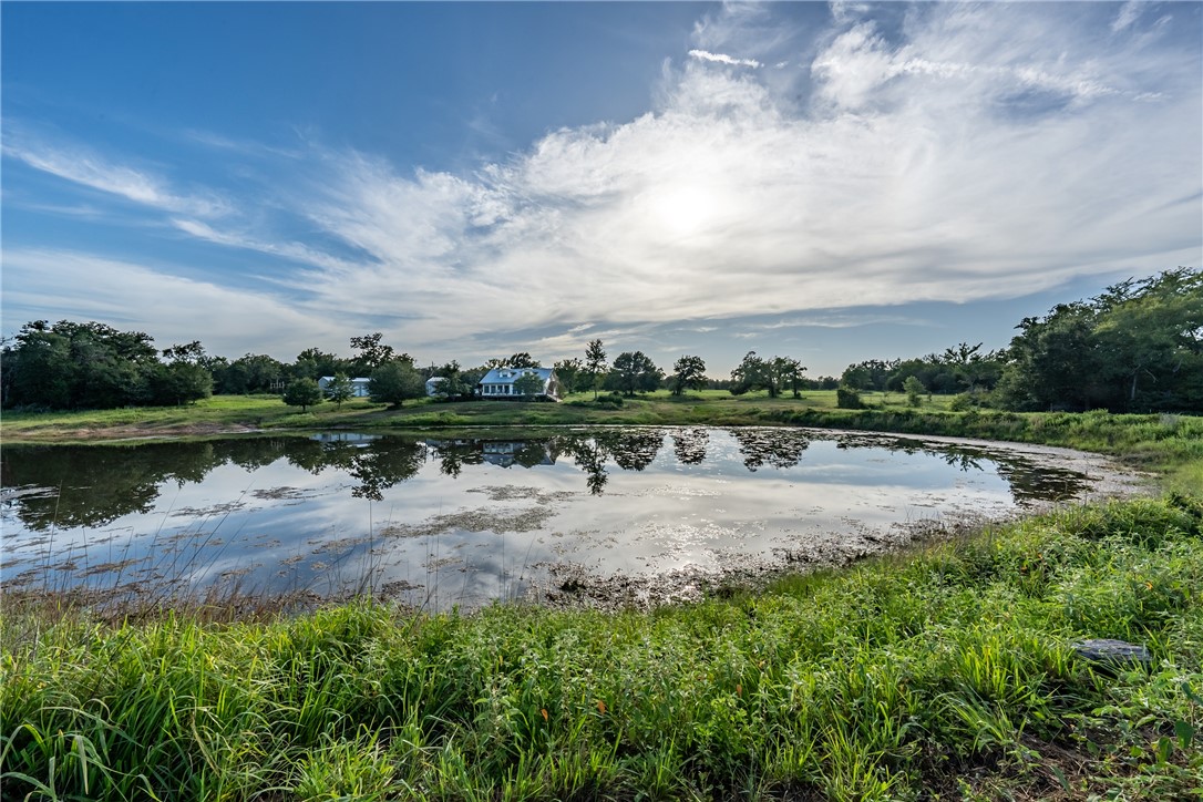 2033 Lcr 704, Unit COUNTYROAD Kosse, TX 76653 - Photo 3 of 31 a view of a lake with houses in the back