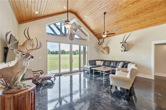 a view of a dining room with furniture a chandelier and wooden floor