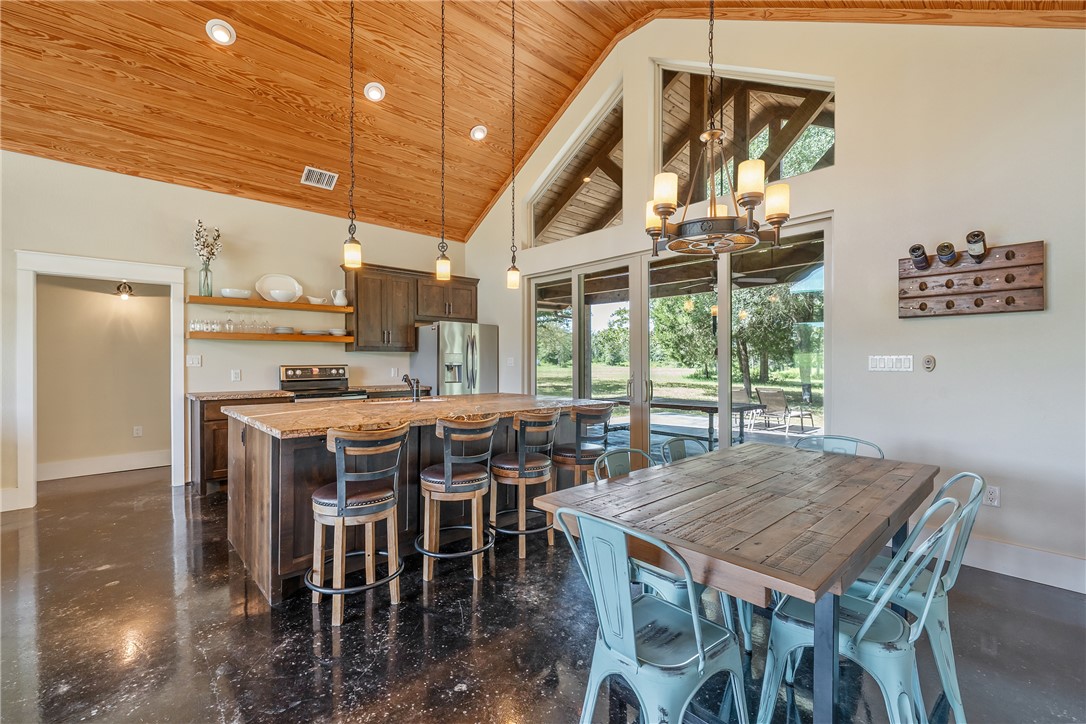 2033 Lcr 704, Unit COUNTYROAD Kosse, TX 76653 - Photo 7 of 31 a dining room with furniture a rug and a chandelier