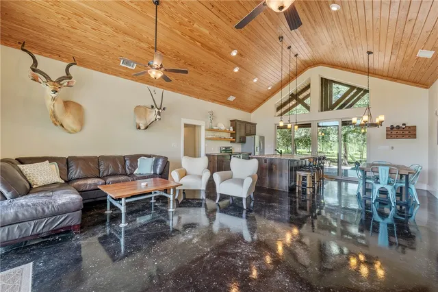 a living room with lots of furniture and a large window